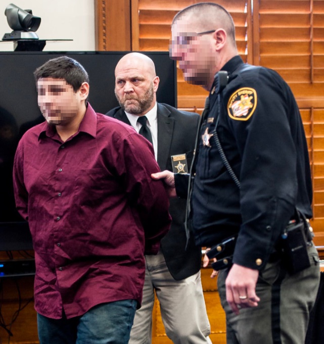 David Lashley on duty in a courtroom, escorting a defendant alongside a sheriff's deputy